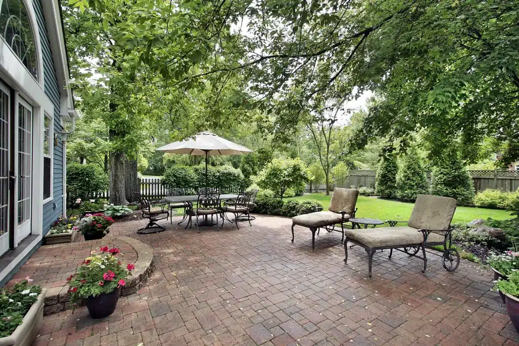 Brick patio with table umbrella and chairs. Your Patio in Summer