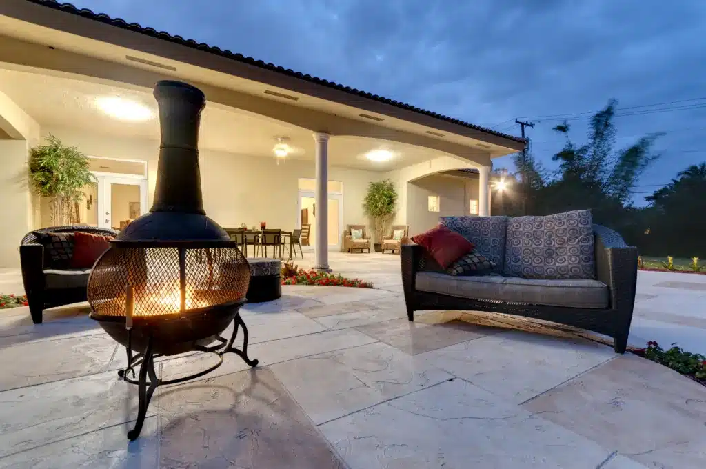Fire pit in a modern backyard with patio furniture. Your Patio in Summer